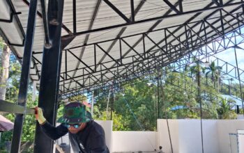Pembangunan KDKMP Lipumangau Diperkuat, Babinsa Pantau Pemasangan Atap dan Instalasi Listrik